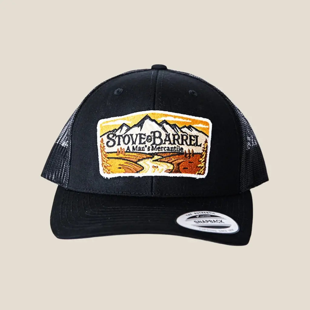 Black trucker hat with Stove & Barrel mountain logo patch, men's mercantile style cap