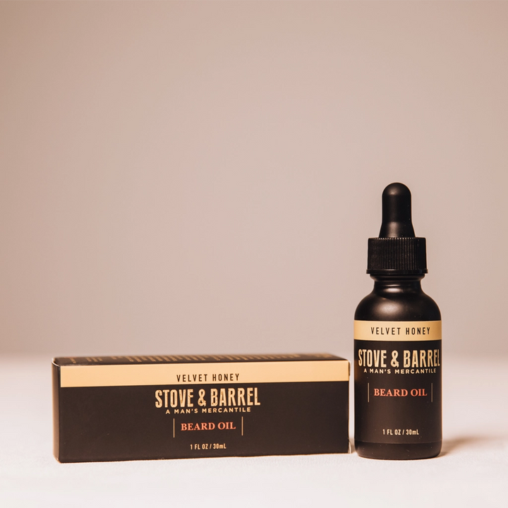 Velvet Honey beard oil in sleek black bottle with dropper, beside matching box, for men's grooming