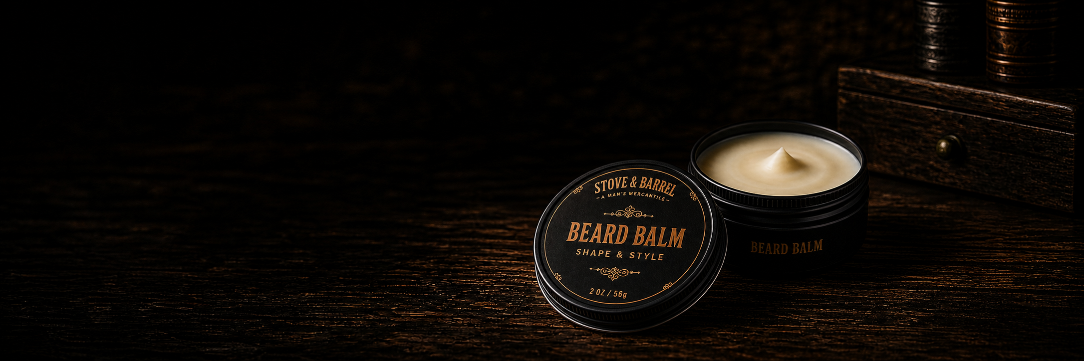 Beard balm in black tin with gold label, open to show creamy texture, on dark wood surface