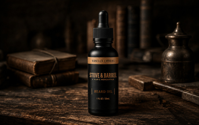Vanilla Embers beard oil in sleek black bottle with dropper, set on rustic wood with vintage books